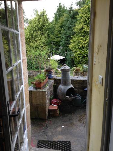 a view of a garden from an open door at Val d'Arguenon in Jugon Les Lacs