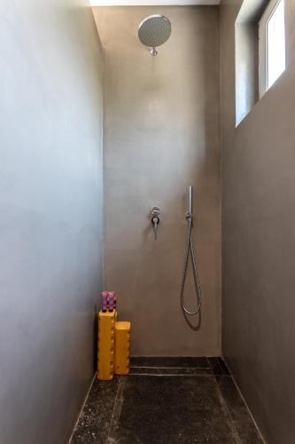 a shower stall in a bathroom with a shower head at Aegean Gem in Kamari