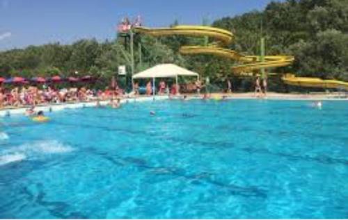 a large swimming pool with a water park at Il sasso bed & breakfast in Sasso di Castalda