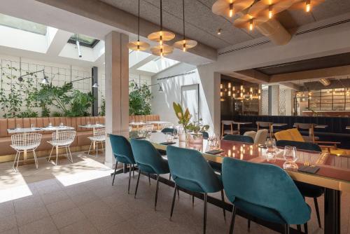 a restaurant with a long table and chairs at The Box Riccione - Adults Only in Riccione