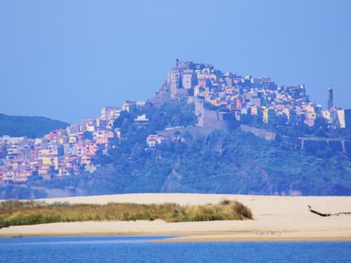 a city on top of a hill next to a body of water at Sa Fiorida case vacanze in Valledoria