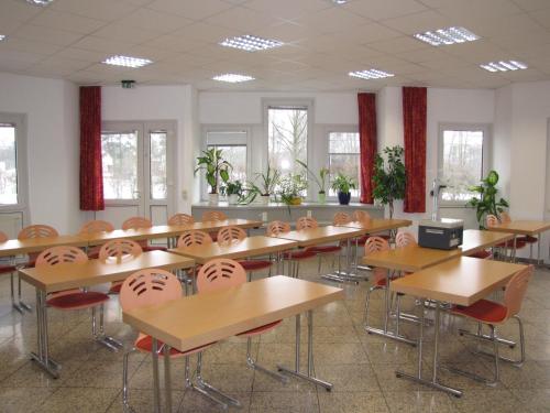 a classroom with rows of tables and chairs at Grunau Hotel in Bayreuth