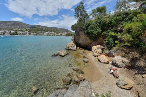 a view of a beach with rocks and the water at Villa PortoMare in Porto Rafti