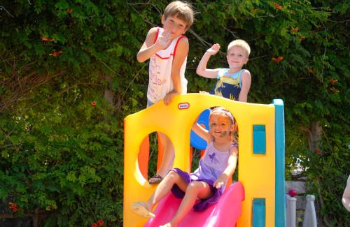 three children standing on top of a play equipment at Samara Hotel Bodrum Ultra All Inclusive in Torba
