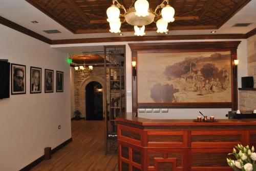 a room with a painting on the wall and a counter at Hotel Kastro in Gjirokastër