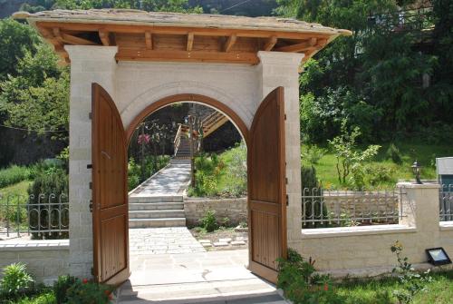 an entrance to a garden with an archway at Hotel Kastro in Gjirokastër