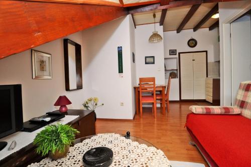 a living room with a red couch and a table at Apartment Maja in Dubrovnik