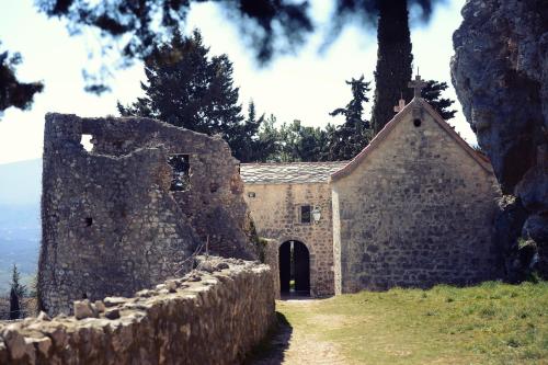 an old stone building with a gate and a stone wall at Ivica Apartments in Imotski