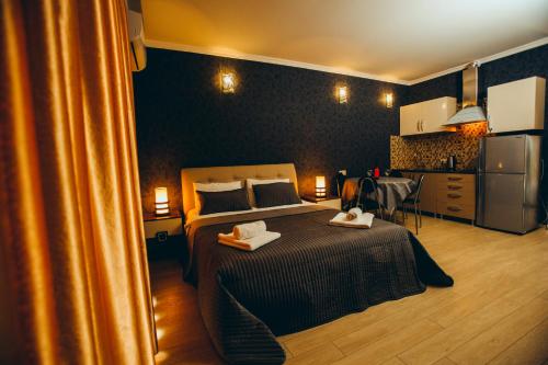 a bedroom with a bed with two towels on it at Sea Towers Suite in Batumi