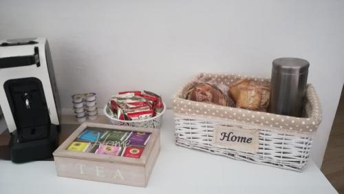 a table with two baskets of items and a coffee maker at Casa Antica in Fasano