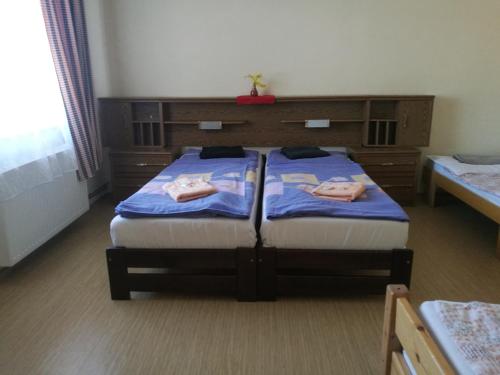 a bedroom with two beds with towels on them at Hotel Chata in Volary