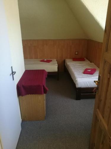a room with two beds with red towels on them at Hotel Chata in Volary