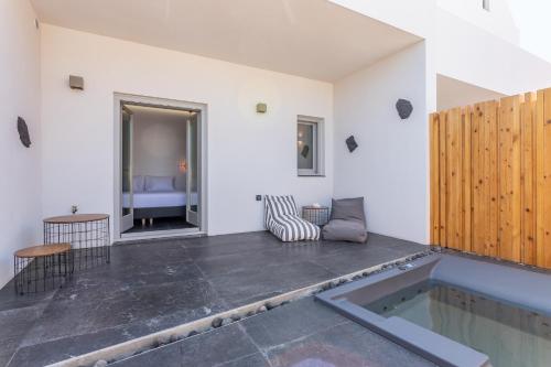 a room with a swimming pool in the middle of a building at Aegean Gem in Kamari