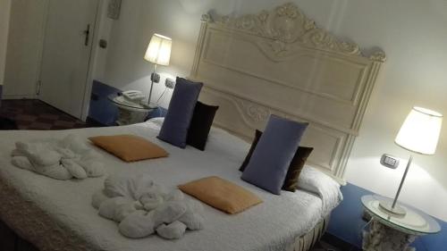 a bedroom with a bed with stuffed animals on it at Art Hotel Al Fagiano in Padova