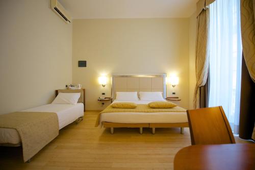 a hotel room with two beds and a table at Best Western Crystal Palace Hotel in Turin