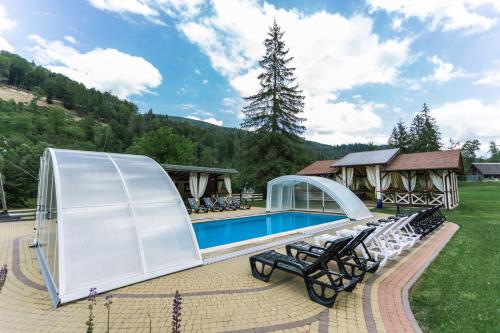 a pavilion with a swimming pool in a yard at Tsarynka Eco Complex in Slavske