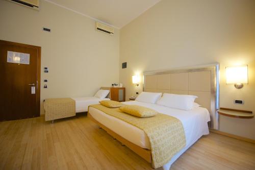 a hotel room with two beds and a table at Best Western Crystal Palace Hotel in Turin