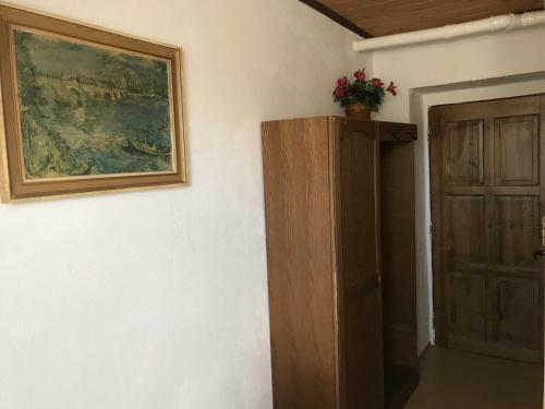 a room with a painting and a wooden door at Hotel Chata in Volary