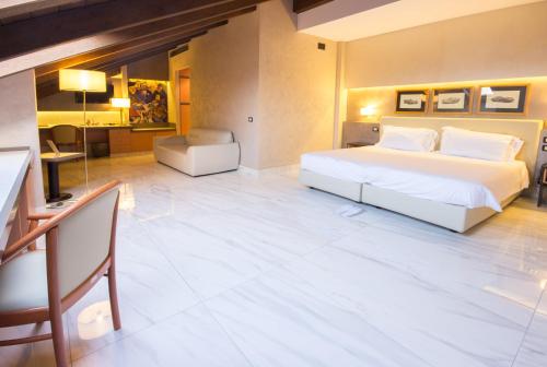 a bedroom with a large white bed and a desk at Best Western Modena District in Campogalliano