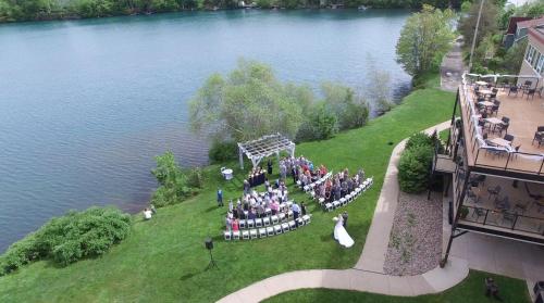 a group of people standing on the grass near a lake at Best Western Plus Chocolate Lake Hotel - Halifax in Halifax