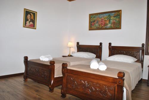 two twin beds in a room with at Hotel Kastro in Gjirokastër