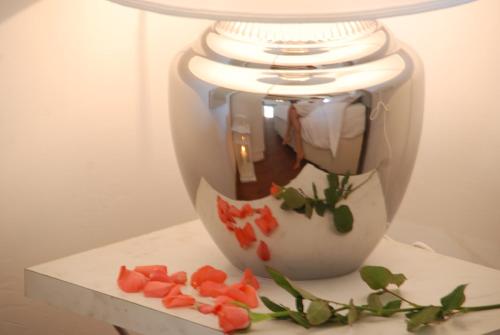 a vase with flowers on it sitting on a table at Casa Cara in Birgu