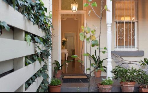 a porch with potted plants on the side of a house at Gorgeous Subiaco cottage in Perth