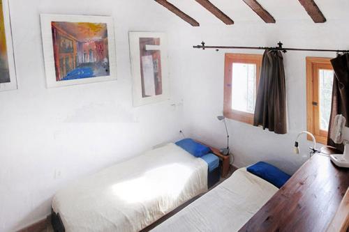 a bedroom with two beds in a room with a window at Cortijo la Venta in Nerja