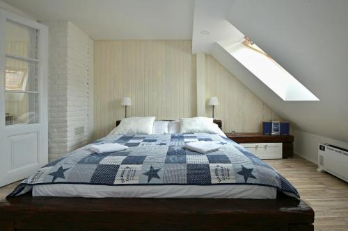 a bedroom with a bed with a blue and white quilt at CASTLE AREA BLATNÁ in Blatná