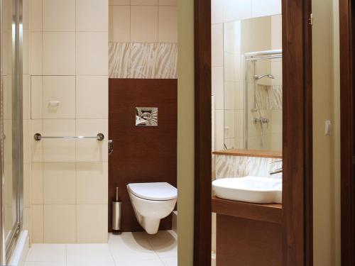 a bathroom with a toilet and a sink at Apartamenty Junior in Wrocław