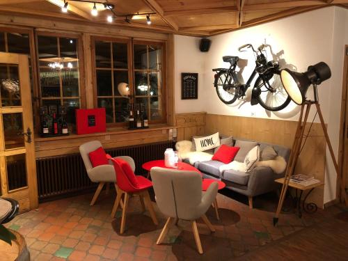 a living room with a bike hanging on the wall at Boutique Hotel Beau-Séjour & Spa Superior in Champéry