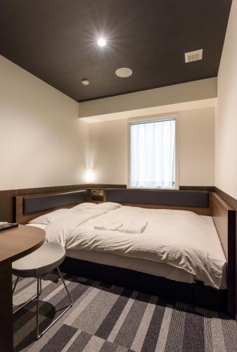 Una cama o camas en una habitación de Belken Hotel Kanda