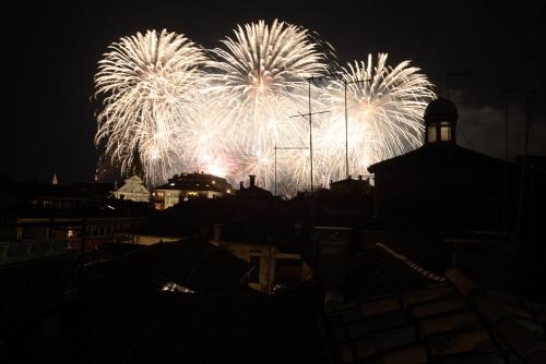 a firework display in the night sky over a city at Residence La Fenice in Venice