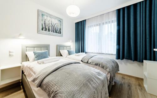 Posteľ alebo postele v izbe v ubytovaní Apartamenty Sun & Snow Sarnia Residence