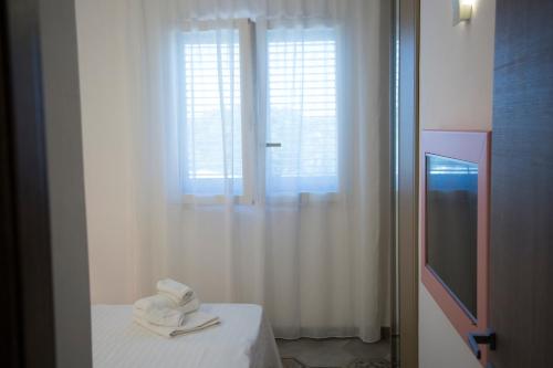 Postel nebo postele na pokoji v ubytování Le Suites del Carrubo