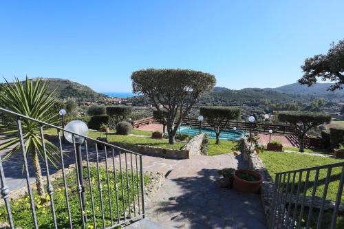 uma vista para um resort com uma piscina e árvores em ARGENTARIO Laura's POOL VILLA em Porto Ercole