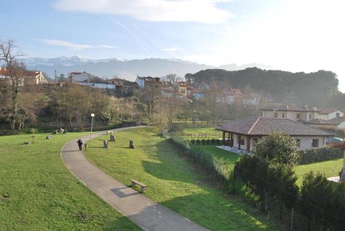 a person walking down a path in a park at The Cool Houses in Llanes