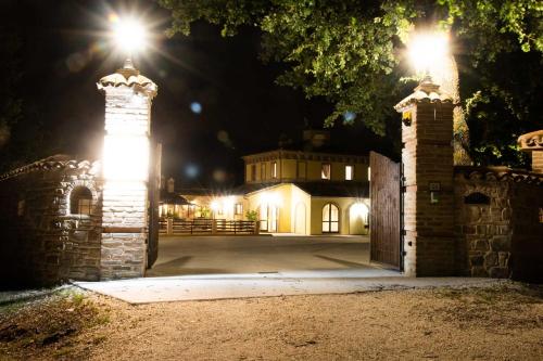 an entrance to a house at night with lights at BorgoPratole CountryHouse in Cingoli
