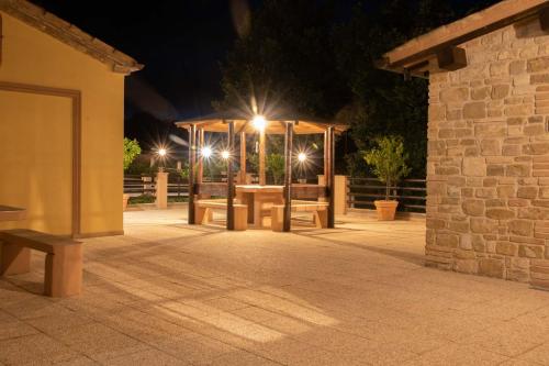 a pavilion with lights on top of it at night at BorgoPratole CountryHouse in Cingoli