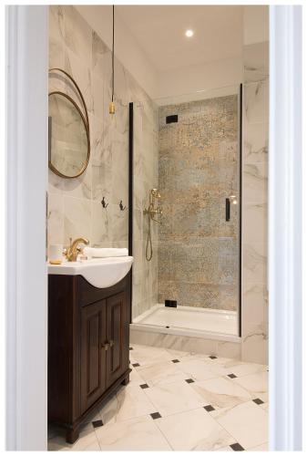 a bathroom with a sink and a shower at Stylish - Centre Apartment Theatre View in Rijeka