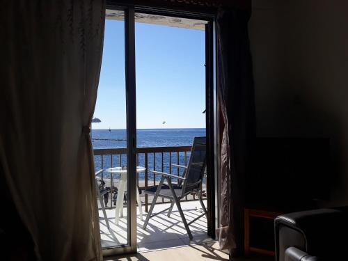 a room with a balcony with a view of the ocean at 777 Beach Guesthouse in Paphos City
