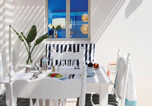 a white table topped with a white table cloth at One Marine Drive Boutique Hotel in Hermanus
