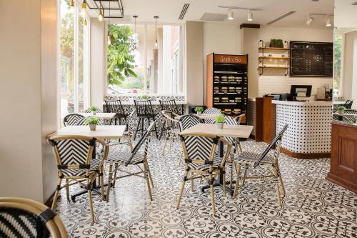 a restaurant with tables and chairs in a room at Radisson Hotel Panama Canal in Panama City