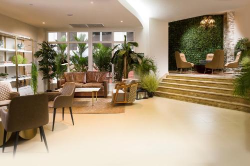 a lobby with chairs and a table and stairs at Radisson Hotel Panama Canal in Panama City