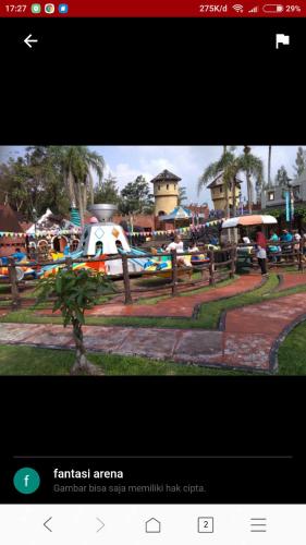 a picture of an amusement park with a plane at Vila Kota Bunga Private Pool in Puncak