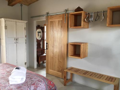 a bedroom with a bed and a wooden door at The Ruskamer Cottage at In the End in Stanford