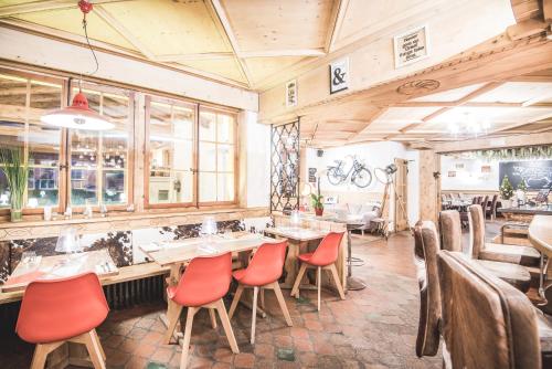 a restaurant with tables and chairs in a room at Boutique Hotel Beau-Séjour & Spa Superior in Champéry