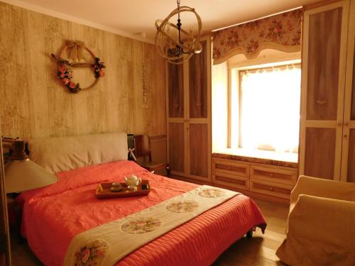 a bedroom with a red bed and a window at 1957 To Rodo kai to Roido in Karpenision