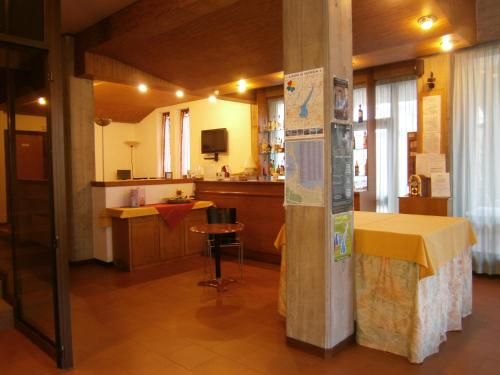 a room with a kitchen with a table and a counter at Hotel Chiara in Sirmione
