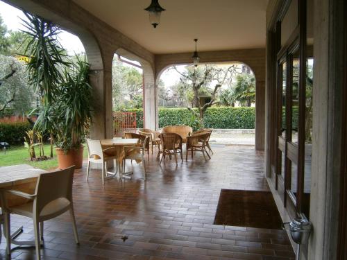 an empty patio with tables and chairs and a patio at Hotel Chiara in Sirmione